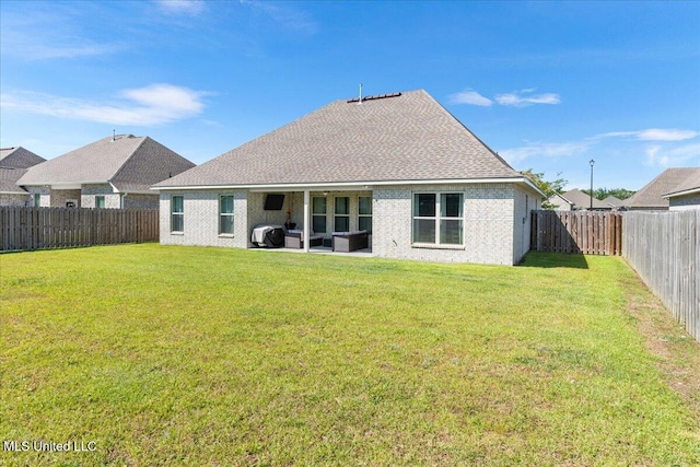 rear view of property with a patio area and a shingled roof