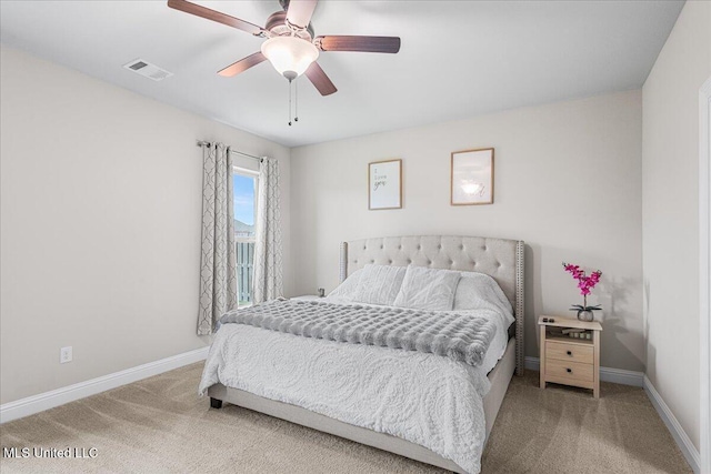 carpeted bedroom with baseboards and a ceiling fan