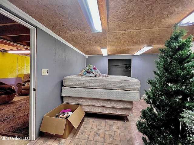 bedroom featuring brick floor