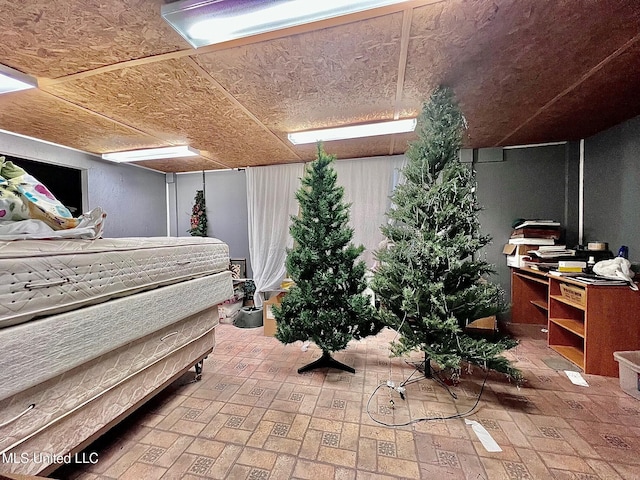 bedroom featuring brick floor