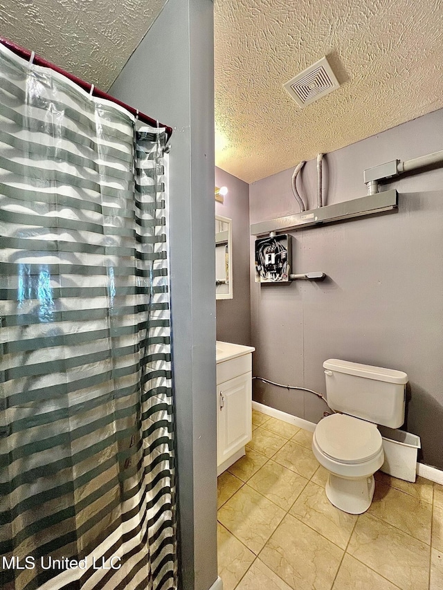 bathroom with baseboards, visible vents, toilet, a textured ceiling, and vanity