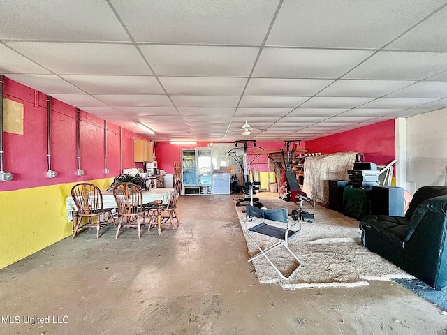 interior space with a paneled ceiling and concrete floors