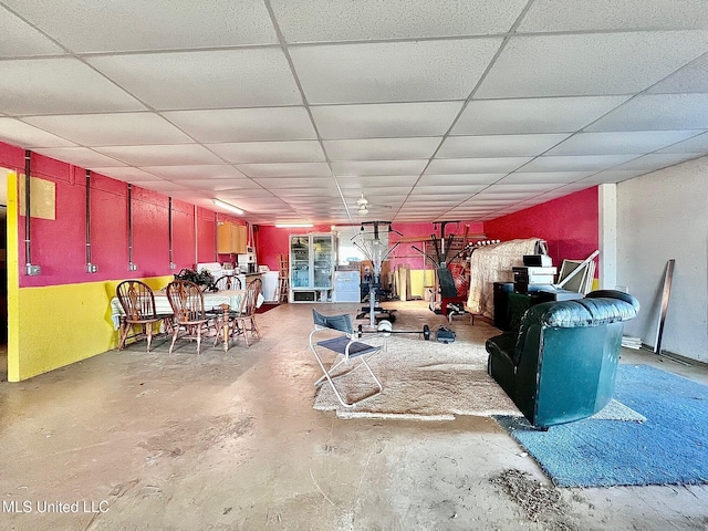 interior space featuring concrete floors and a drop ceiling