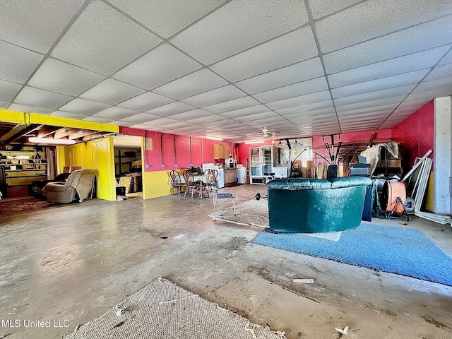 miscellaneous room featuring concrete flooring and a paneled ceiling