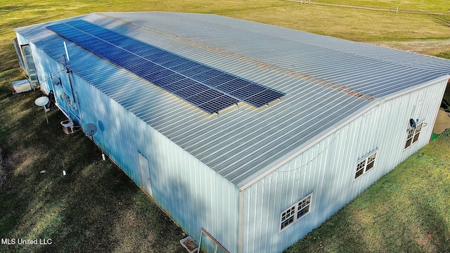 view of property exterior featuring roof mounted solar panels