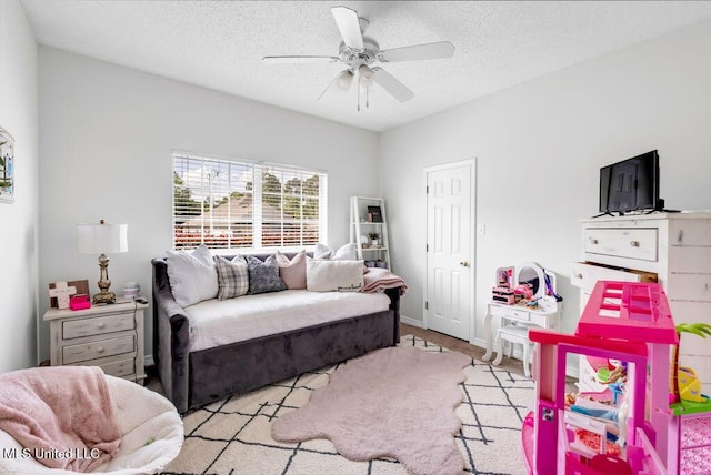10840 Ala Moana St, Diamondhead, MS 39525 - living room with ceiling fan, a textured ceiling, light colored carpet, and baseboards