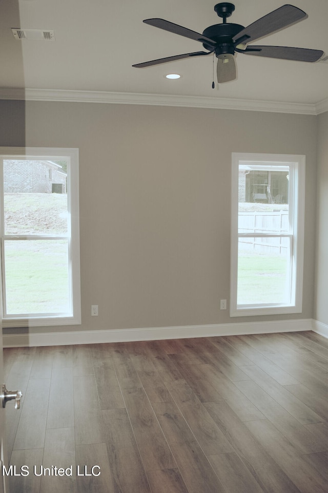 unfurnished room with ceiling fan, crown molding, and hardwood / wood-style floors