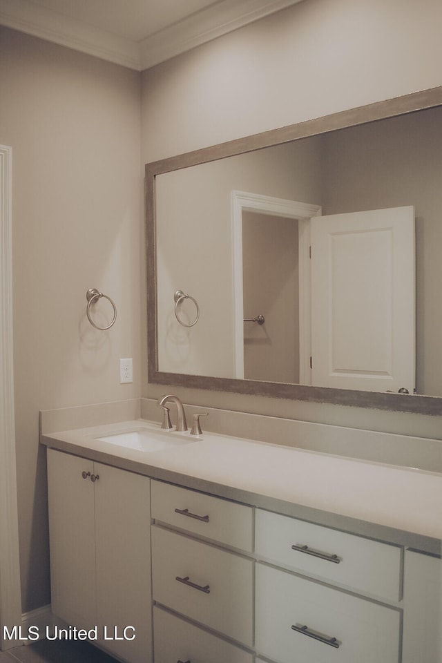 bathroom with vanity and ornamental molding