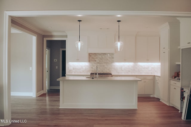 kitchen featuring white cabinets, a kitchen island with sink, and dark hardwood / wood-style flooring