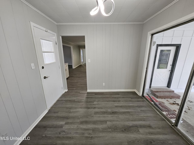interior space featuring baseboards, ornamental molding, dark wood finished floors, and a chandelier
