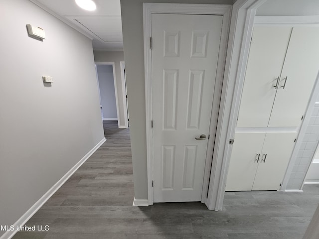 hallway with baseboards and wood finished floors