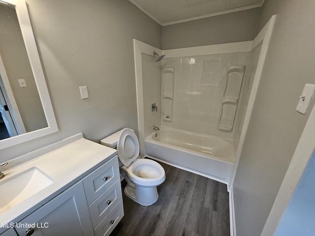 full bathroom with crown molding, vanity, toilet, wood finished floors, and  shower combination