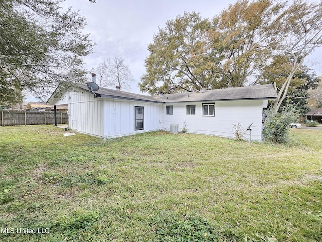 back of house with a yard, fence, and cooling unit