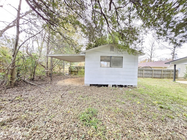 view of outbuilding with fence