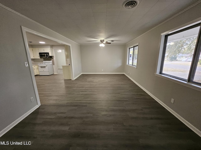 interior space with visible vents, ornamental molding, dark wood finished floors, and a ceiling fan