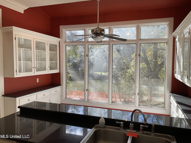 kitchen with ceiling fan, sink, crown molding, decorative light fixtures, and white cabinets