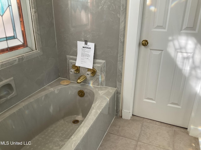 bathroom featuring a tub and tile patterned flooring