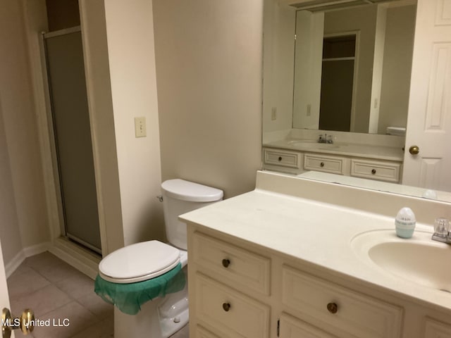 bathroom with tile patterned flooring, vanity, toilet, and an enclosed shower