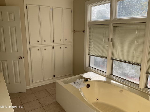 bathroom featuring tile patterned floors and a washtub