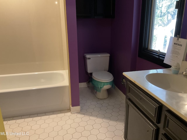 bathroom with a tub to relax in, vanity, and toilet