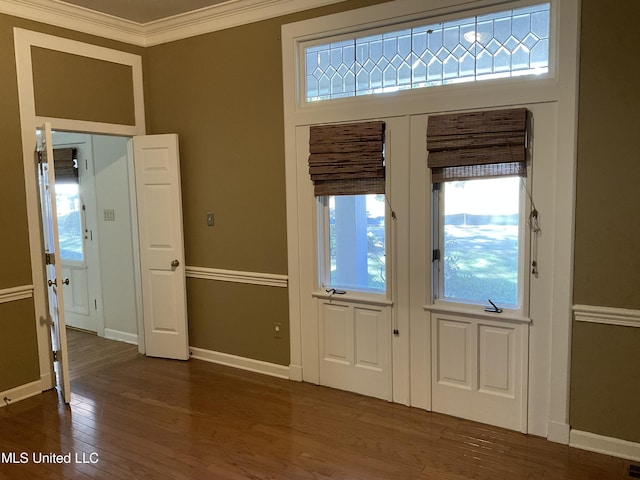 foyer entrance featuring ornamental molding and dark wood-type flooring