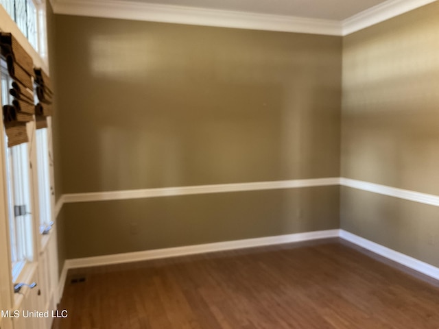 unfurnished room featuring dark hardwood / wood-style floors and crown molding