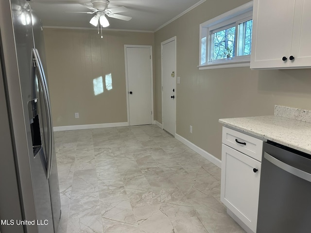 kitchen with white cabinetry, ornamental molding, ceiling fan, stainless steel appliances, and light stone countertops