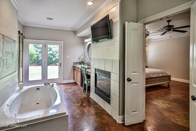 2948 Grove Meadows Dr, Nesbit, MS 38651 - bathroom featuring crown molding, a tub with jets, connected bathroom, a tiled fireplace, and ceiling fan