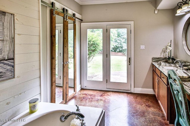 2948 Grove Meadows Dr, Nesbit, MS 38651 - doorway with a sink, a barn door, finished concrete floors, ornamental molding, and baseboards
