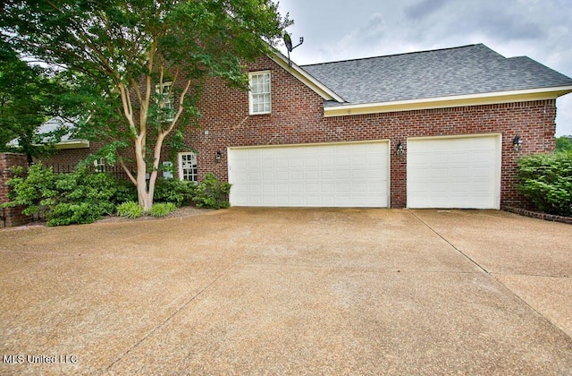 2948 Grove Meadows Dr, Nesbit, MS 38651 - view of side of home featuring driveway, roof with shingles, and brick siding