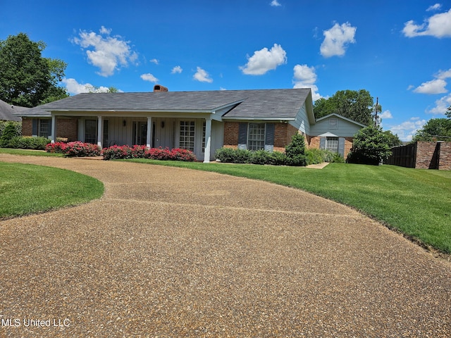 719 Sumner Ave, Greenwood, MS 38930 - view of front of property featuring brick siding, a front lawn, and board and batten siding