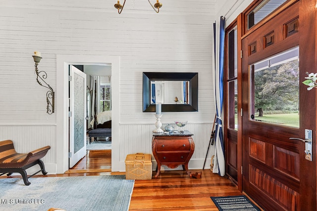 foyer with wooden walls and dark hardwood / wood-style flooring