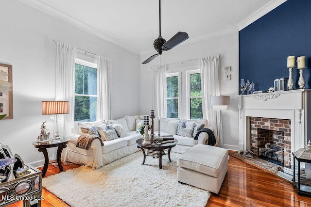 living room featuring a wealth of natural light, crown molding, and wood-type flooring