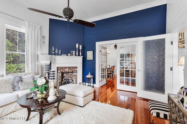 living room with a fireplace and wood-type flooring