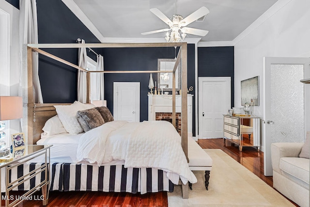 bedroom featuring ceiling fan, crown molding, and hardwood / wood-style floors