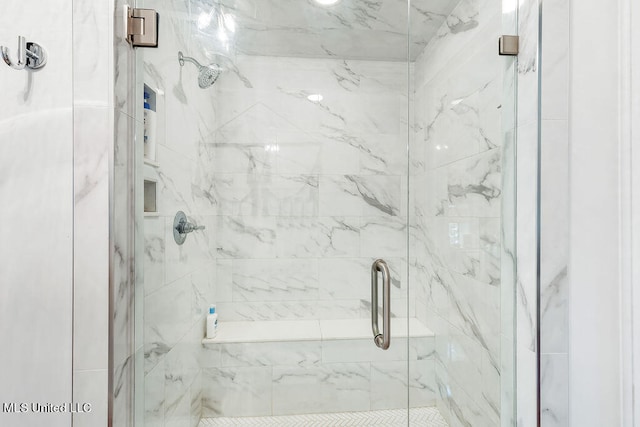 bathroom with a shower with shower door