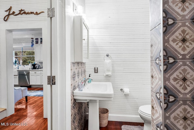 bathroom with toilet and hardwood / wood-style flooring