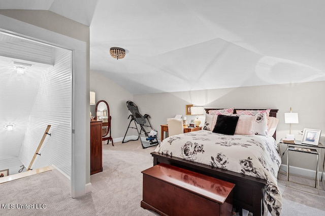 carpeted bedroom featuring lofted ceiling