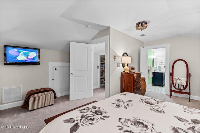 bedroom with connected bathroom, light carpet, and lofted ceiling