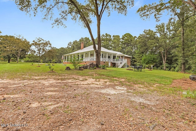 exterior space featuring a front lawn and a wooden deck