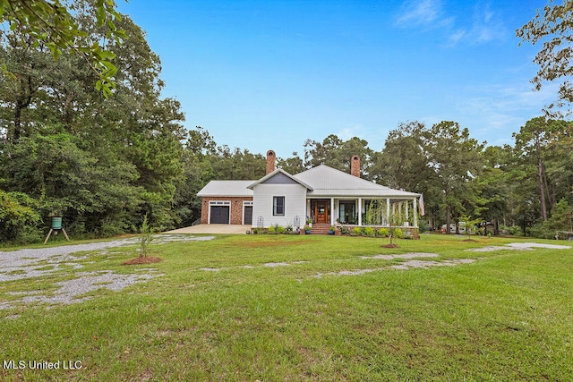 view of front of home with a porch, a front lawn, and a garage