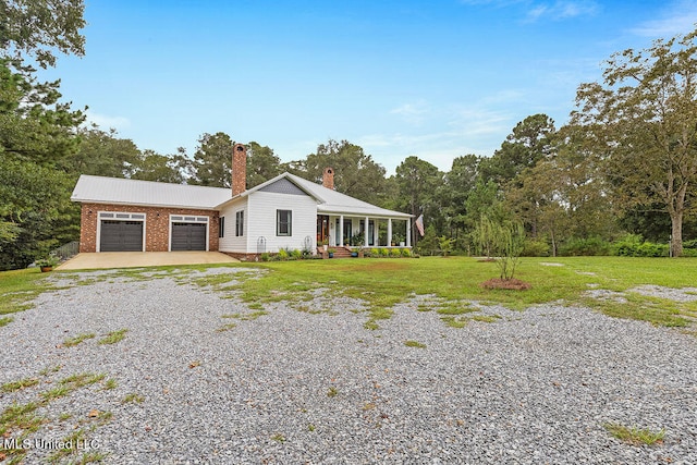 ranch-style house featuring a front yard and a garage