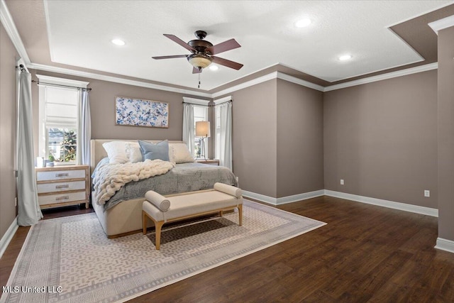 bedroom featuring baseboards, wood finished floors, and crown molding