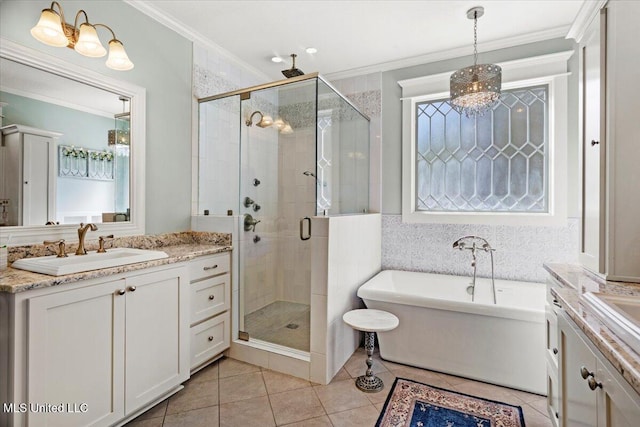 bathroom featuring vanity, a freestanding tub, a stall shower, ornamental molding, and tile patterned flooring