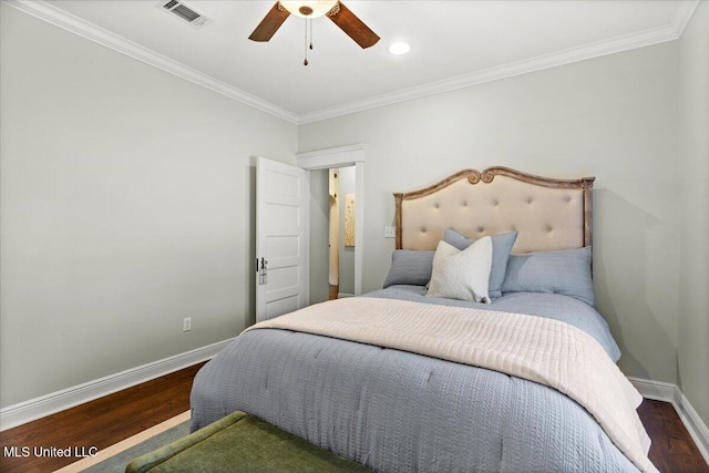 bedroom with visible vents, crown molding, baseboards, wood finished floors, and a ceiling fan