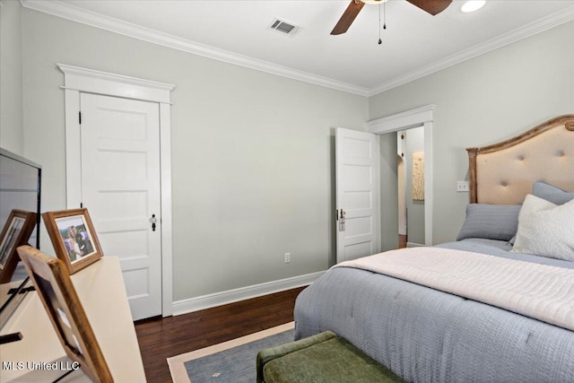 bedroom with visible vents, crown molding, ceiling fan, baseboards, and wood finished floors