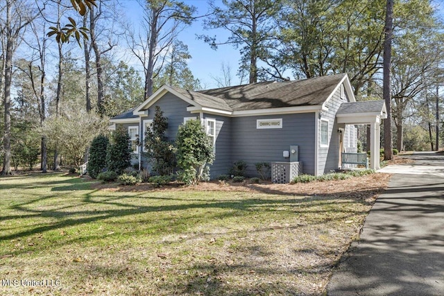 view of property exterior featuring a yard and driveway