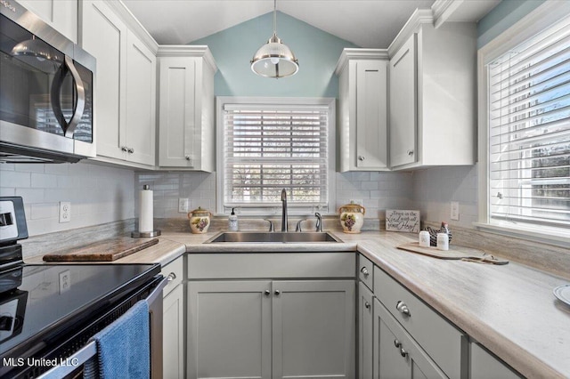 kitchen with a sink, stainless steel appliances, plenty of natural light, and light countertops