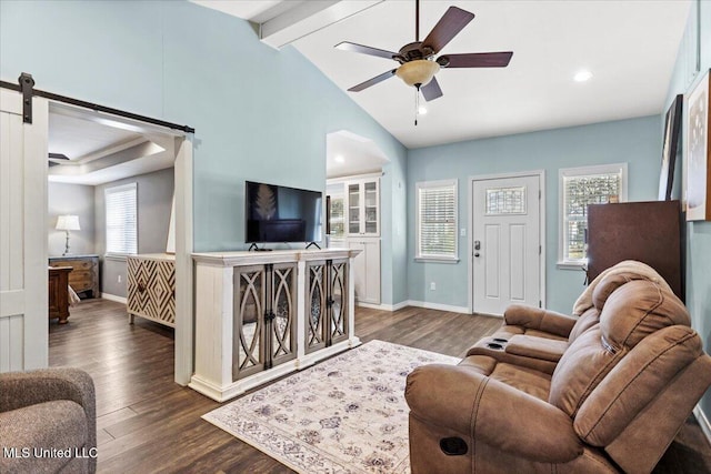 living area with a ceiling fan, a barn door, dark wood-style floors, and baseboards