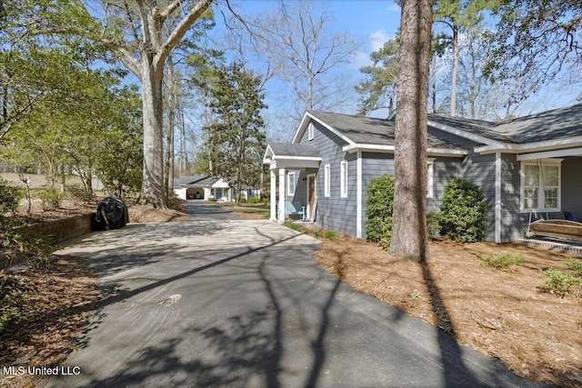 view of property exterior with aphalt driveway